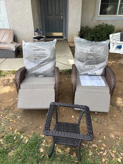 Two matching rocking chairs with glass side coffee table
