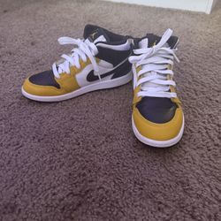 These Are Black,yellow, And White Air Jordan 1 Mids