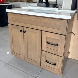 36-inch oak color vanity. Drawers and sink can be configured on either the left or right side. Dimensions: 22” depth × 36” height.