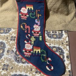 Handmade needlepoint Christmas stocking with Santa Claus and 'Merry Christmas' lettering