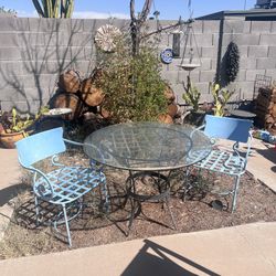 Wrought Iron Bistro Table With Glass Top And Two Metal Chairs