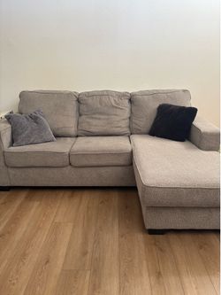 Comfy light gray sectional couch with chase