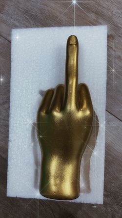 Golden hand sculpture- middle finger