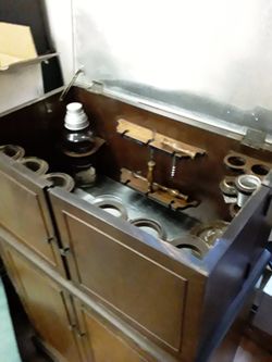 Old prohibition cabinet with castors and glasses, shaker etc