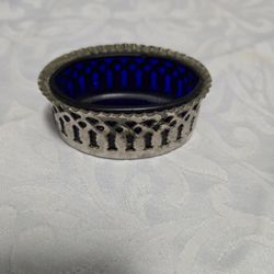 antique sterling silver salt cellar with a cobalt blue glass liner.