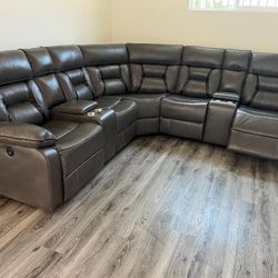New Reclining Sectional .  Grey Gel Leatherette .  106” X 106”.  Free Delivery !