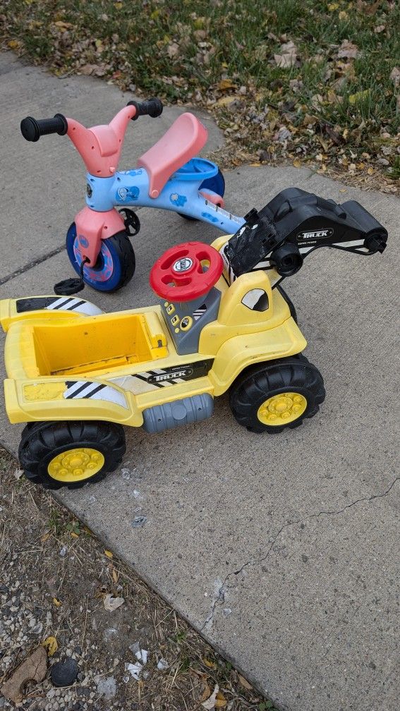 2 Riding Toys. Bike & Yellow Truck Doesn't Have A Seat Or Claw. Just Cheap. West Or East