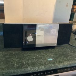 Panasonic Compact Stereo System HC-30, with a center sliding door and an integrated iPod/iPhone dock, customized with an Apple logo sticker on the lef