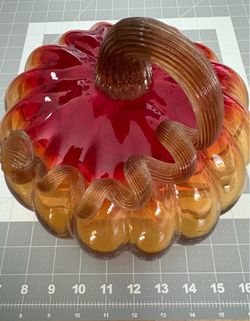 Hand-blown art glass pumpkin with amber and cranberry coloring and applied ribbed stem