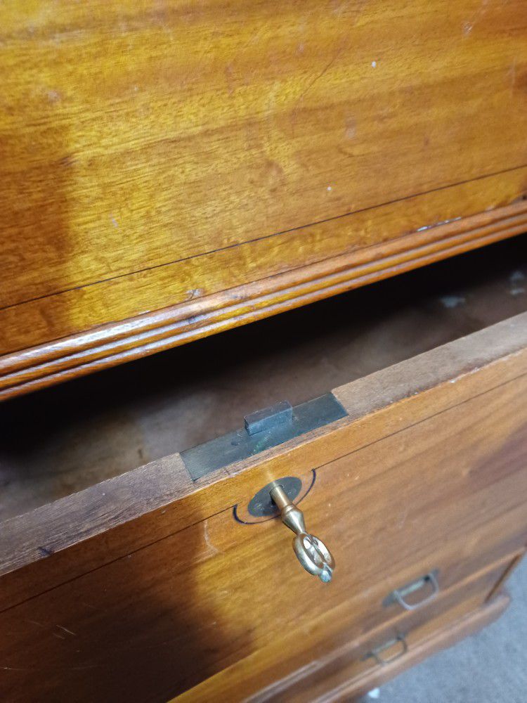 An Antique Dresser With Skeleton Key