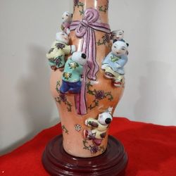 Chinese Orange Famille Rose Seven Children Vase, often given as a gift to newlyweds as a good omen for fertility. The vase is decorated with seven chi