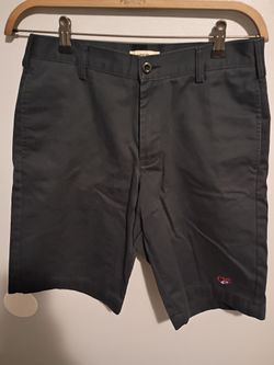 Lands in Delta uniform blue cargo shorts.