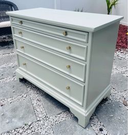 Solid wood dresser with 3 drawers and a pull out tray