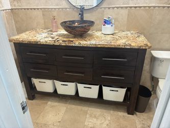 Bathroom vanity with countertop and sink.