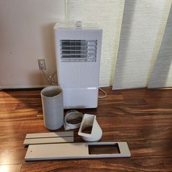 10000 BTU Portable Air Conditioner Cools 450 Sq. Ft. with Dehumidifier and Fan with Remote in White.