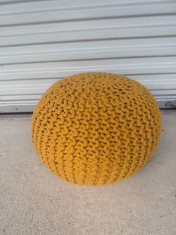 Yellow ottoman - Model home decor