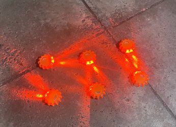 Battery operated set of 6 flashing road flares with carry bag.