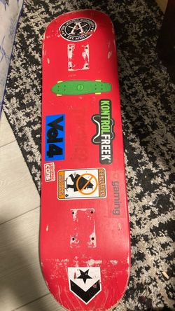 Red Skateboard Deck with Stickers