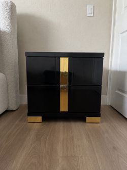 Modern black finish with gold accents. Excellent condition, sturdy, and stylish. Dimensions: 23” x 15”. Perfect as a nightstand, end table, or accent 
