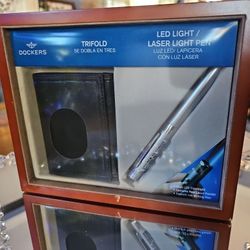 Neq In Package! Vintage, Dockers gift set featuring a black trifold wallet and a silver LED light/laser pointer pen.
Wallet is a trifold. In Wooden Bo