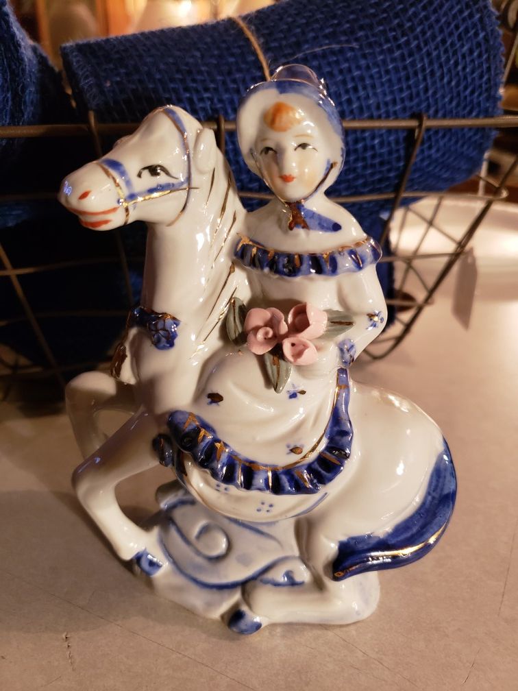 Colonial/Victorian porcelain figurine sitting side saddle with Rose's. Rare find.. Vibrant colors in perfect vintage condition..gold trim.