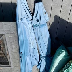 Two 9’ Tilt Umbrellas Faded but Functional 