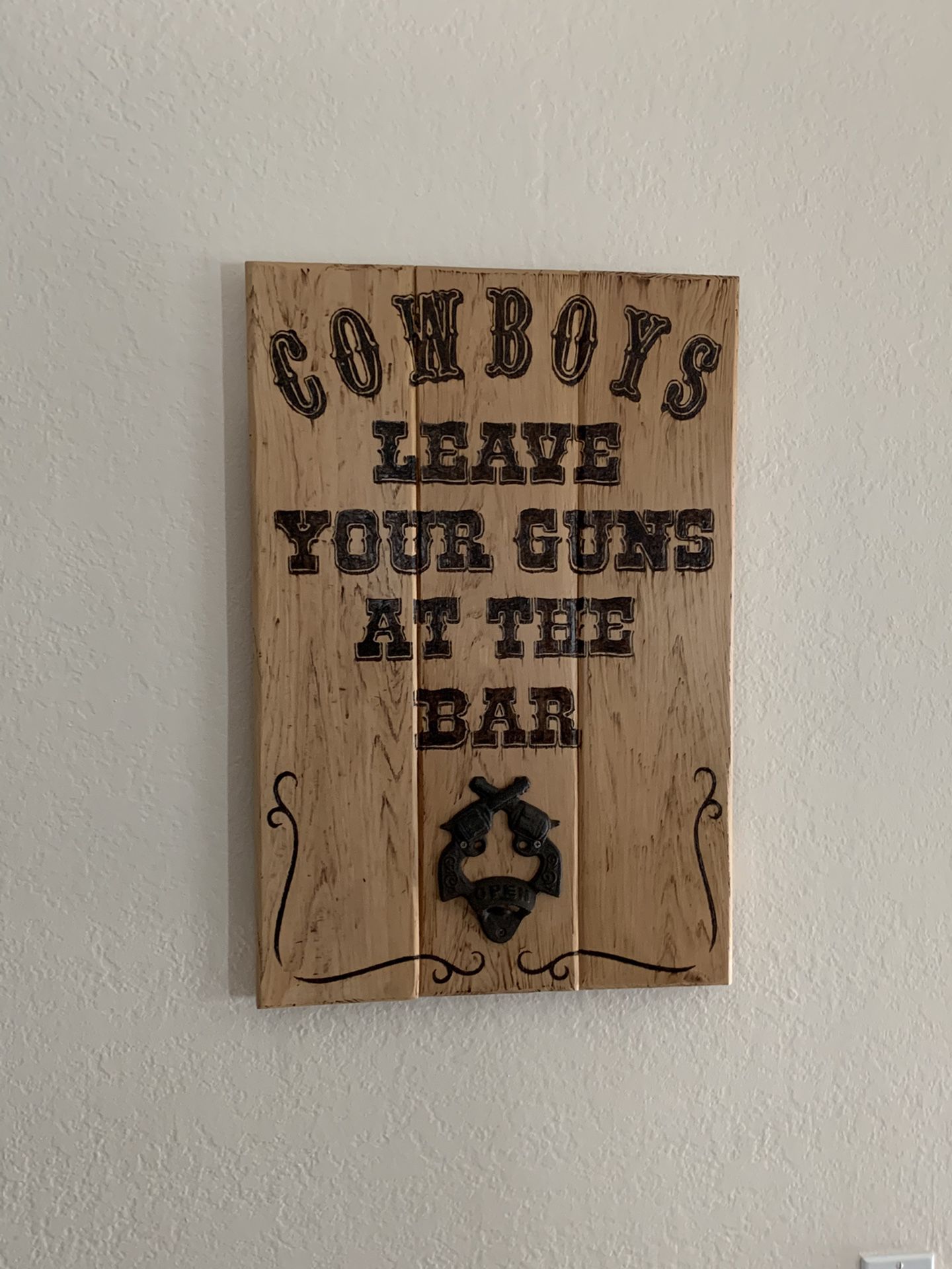 Wooden sign with mounted bottle opener