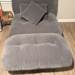 Gray sofa and white oval table with gray veins