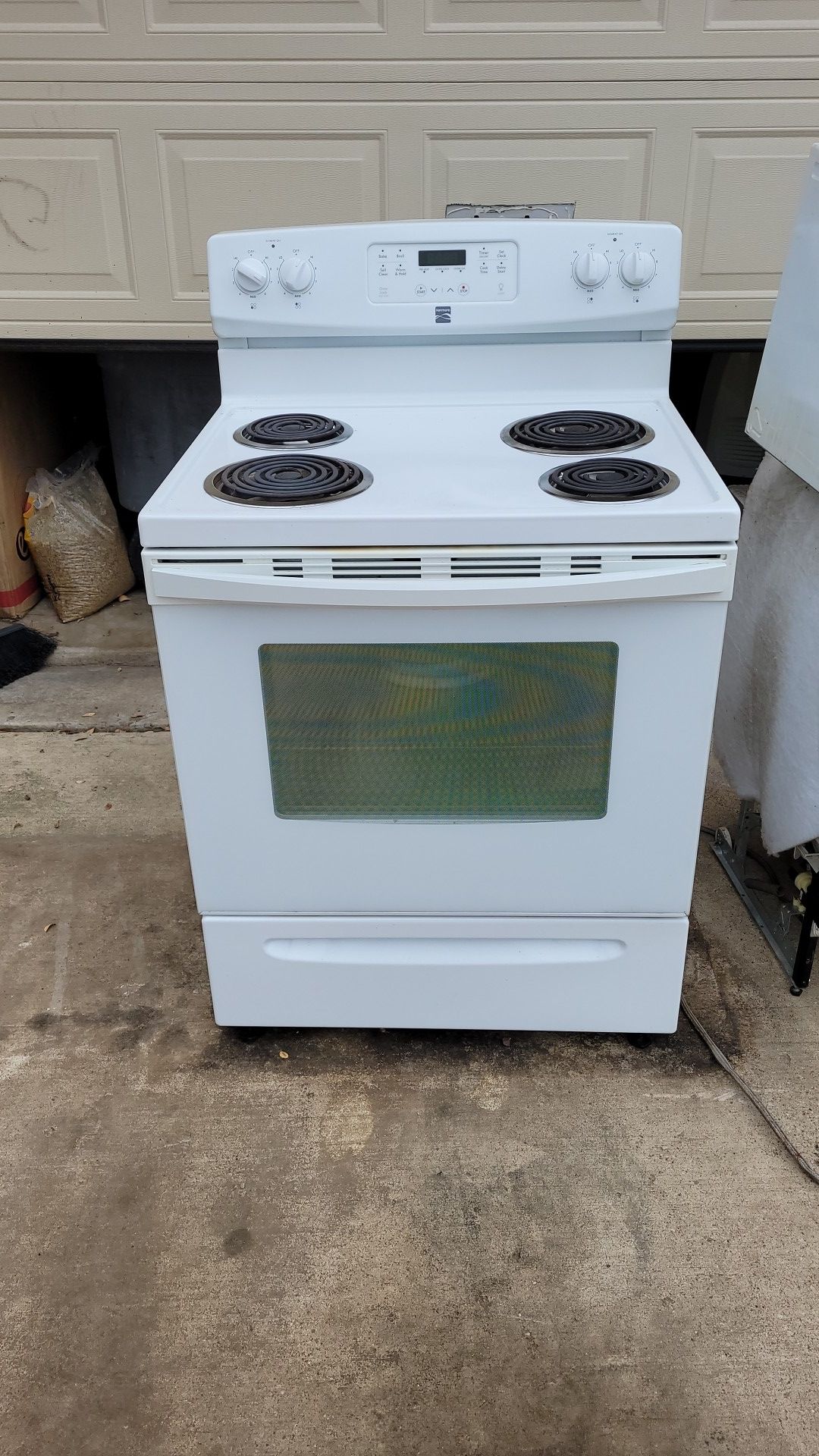 Kenmore electric stove, Samsung over the range microwave and a Roper