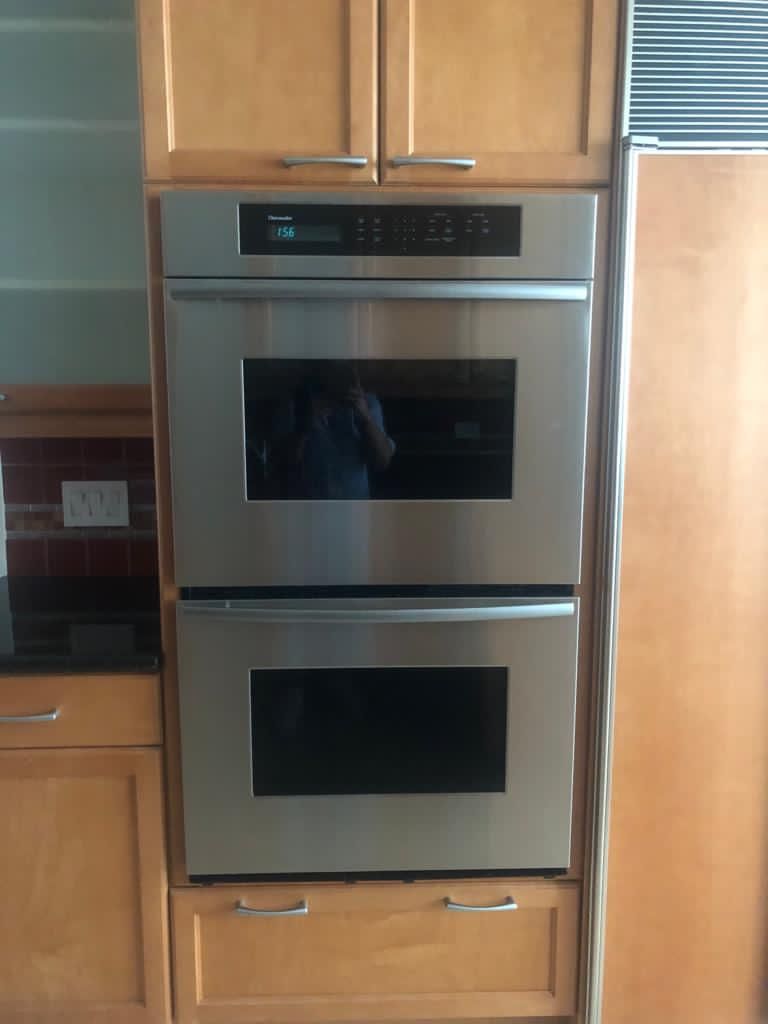 for sale two-door refrigerator sub zero brand, Thermador brand 2 oven combo, whirlpool dishwasher, General Electric microwave.