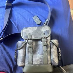 Coach mini backpack in green/gray camouflage Signature print. Adjustable strap, side pockets, front buckle design, and Coach hangtag included. Very cl