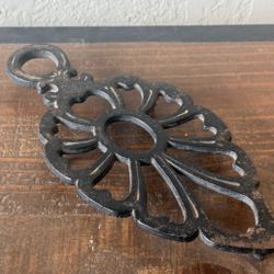 Small Cast Iron Trivet with Ornate Floral Design and Hanging Loop