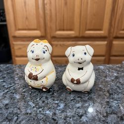 Vintage Pigs Pair of Salt and Pepper Shakers.  Size approximately 2 3/4 inches tall.  Preowned.  Has been on display in a cabinet with a very large sa