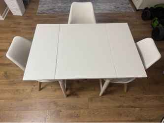white kitchen table with three chairs