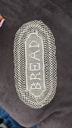 Oval Cream tatted Lace Doily with the word BREAD