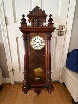This is a vintage Vienna regulator wall clock