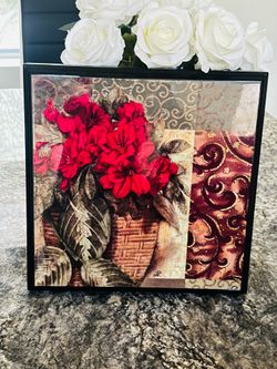 framed piece features a mixed-media or fabric collage style artwork
