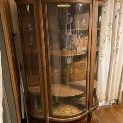 Last chance to make an offer!!Antique  Tiger Oak Curved Glass Curio Cabinet with Claw Feet and Light