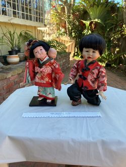 Pair vintage dolls, probably Japanese, mother with baby on back, and young boy, ceramic faces