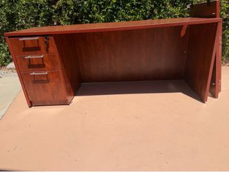 Large brown office desk with file cabinet