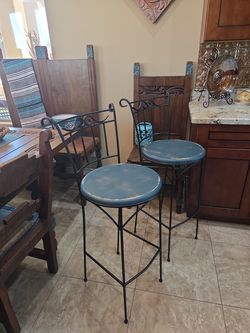 Pair of wrought iron and wood stools