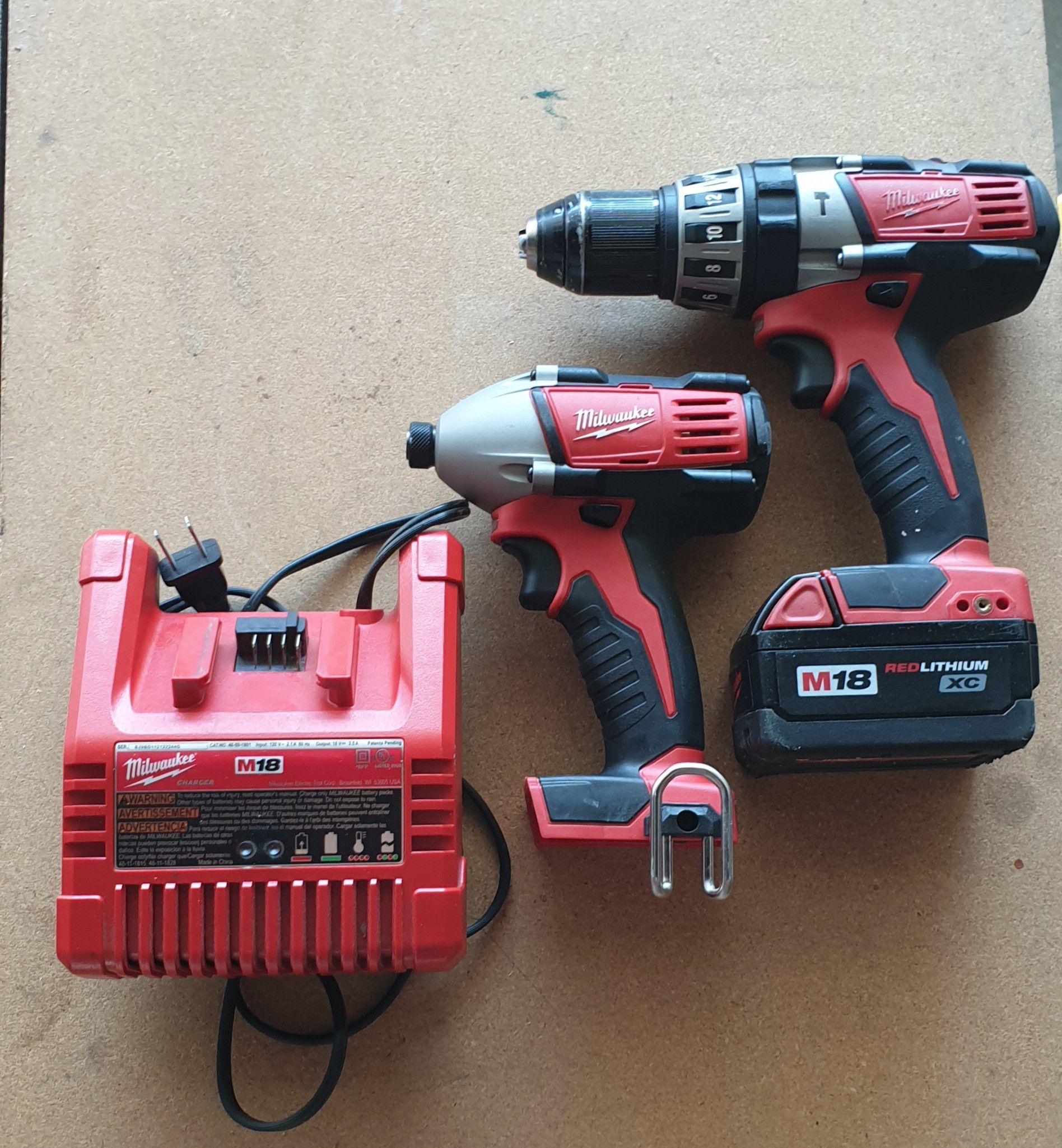 Milwaukee m18 1/2 hammer drill and impact driver combo comes with red lithium xc battery and charger