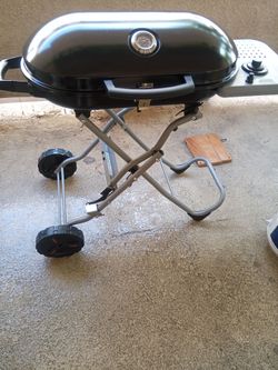 Practically Brand New Portable Propane Gas BBQ Grill With Brand New Propane Tank For Sale.