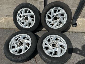Pontiac Grand Am 15 inch wheels and old tires. 5 on 115mm Fits Chevy