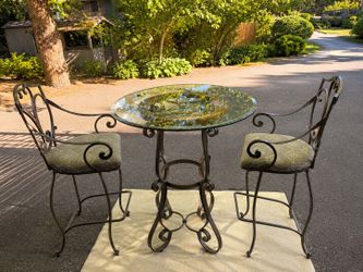 Wrought iron bistro style table with two chairs