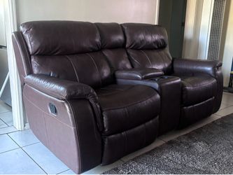 Two sitter leather couch with drink holder and center storage