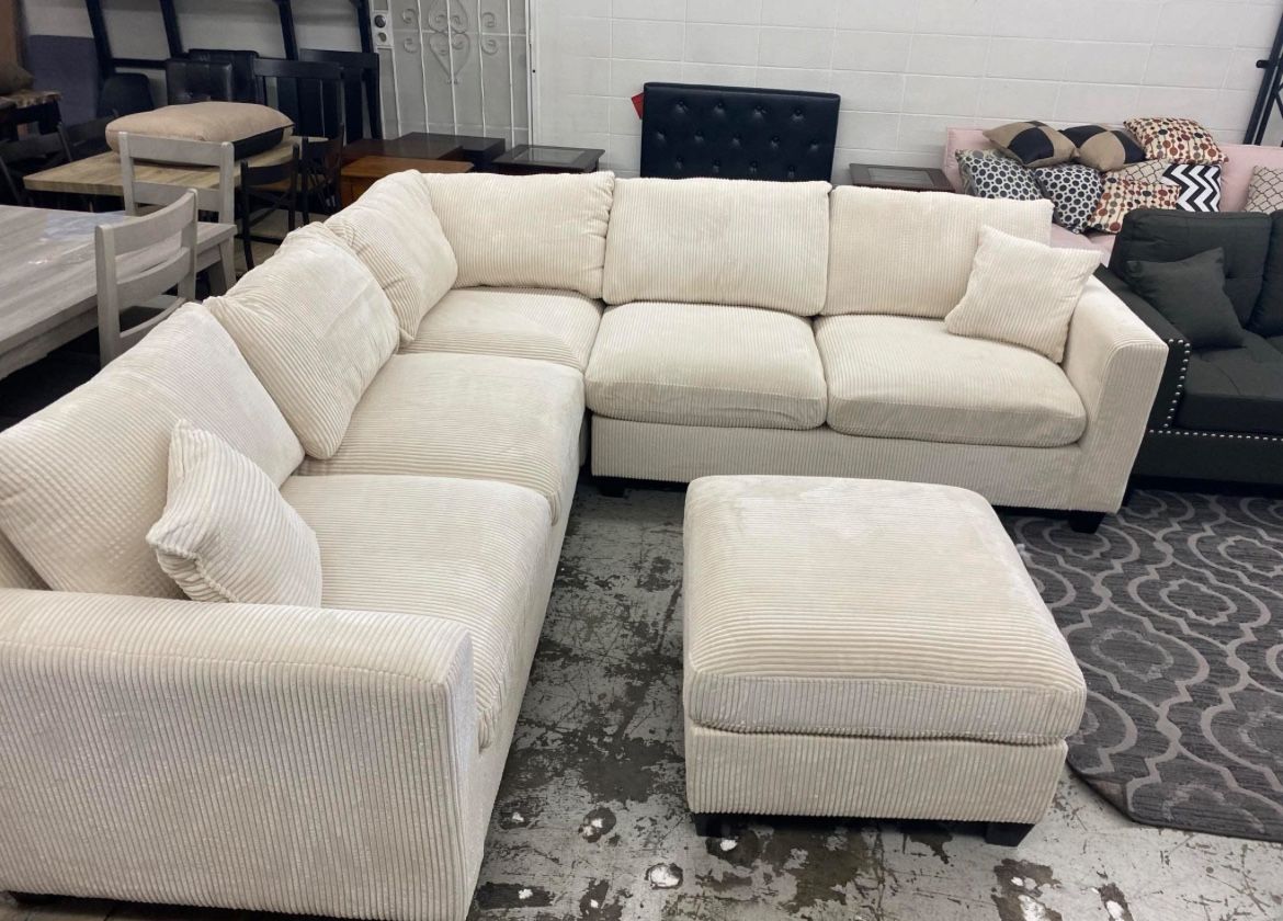 corduroy Sectional Sofa with Ottoman and 2 accent pillows.