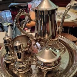 Vintage  silver teapot cream and sugar salt abnd pepper and a serving tray it's vintage asking firm price $45 bucks pick up only 865 Ellsworth