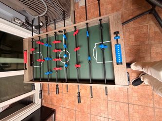 Foosball Table with Red and Blue Players