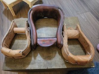 1 LARGE 1" LEATHER COVERED HORSE STIRRUP AND TWO LEATHER COVERED STIRRUPS (2.5")